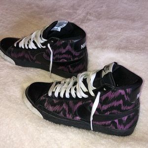 Nike high tops with purple and black zebra stripes